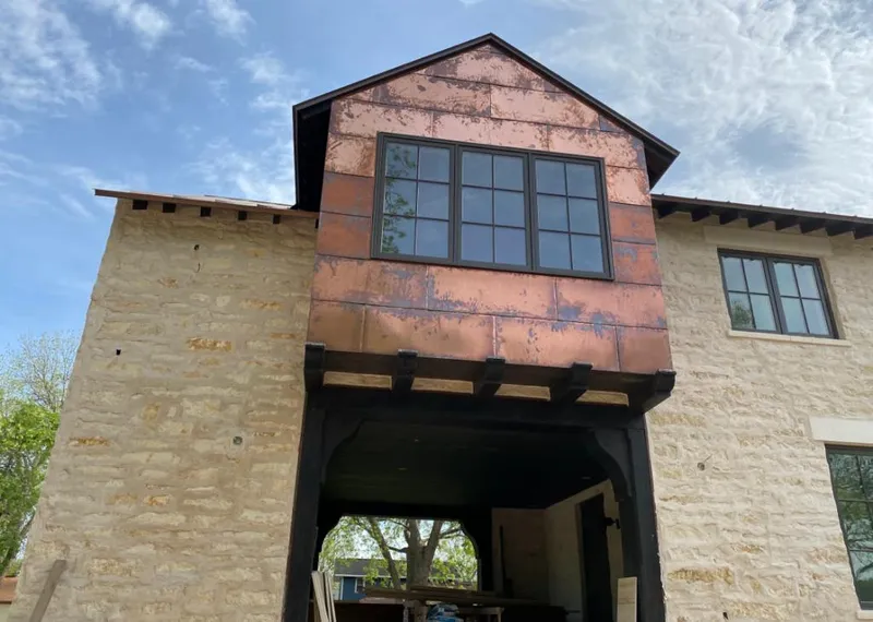 Copper metal panel facade on a stone building for Roof Repair in Little Elm