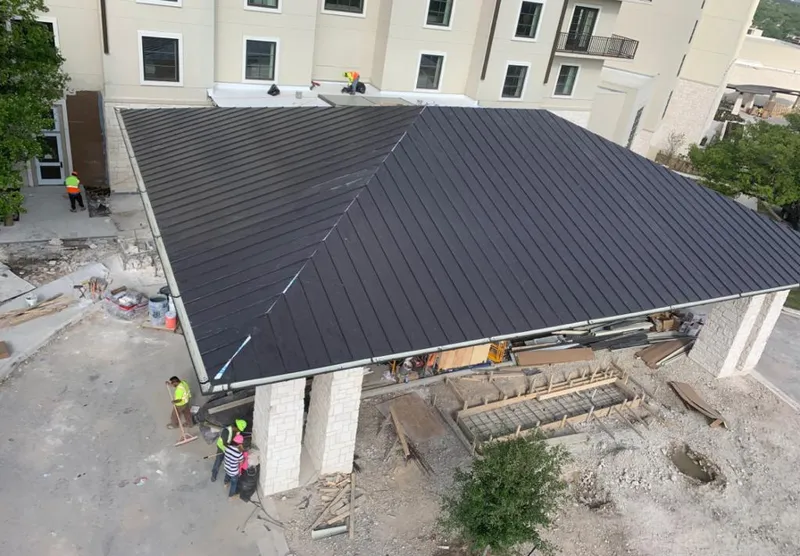 Metal roofing installation team working on a commercial building in Little Elm